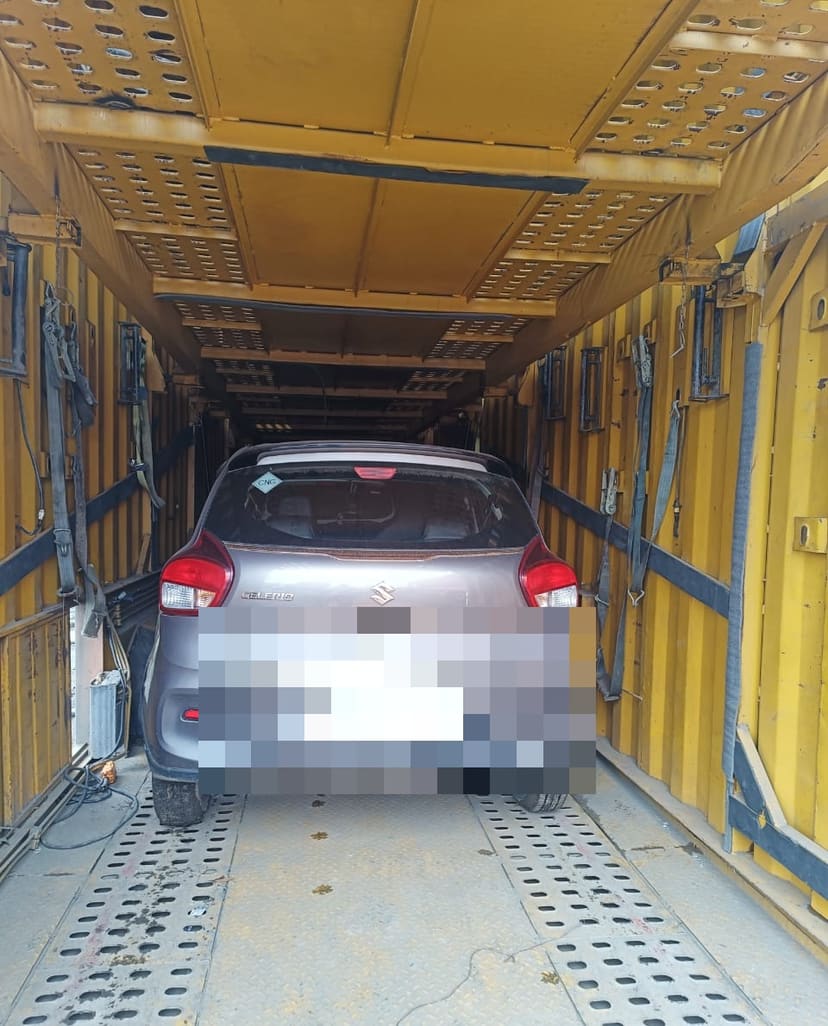 Car standing inside the interior of a vehicle transport carrier