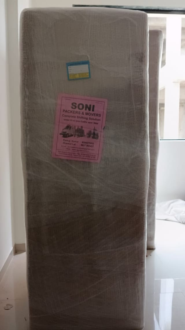 Refrigerator wrapped in protective material with an identification label attached