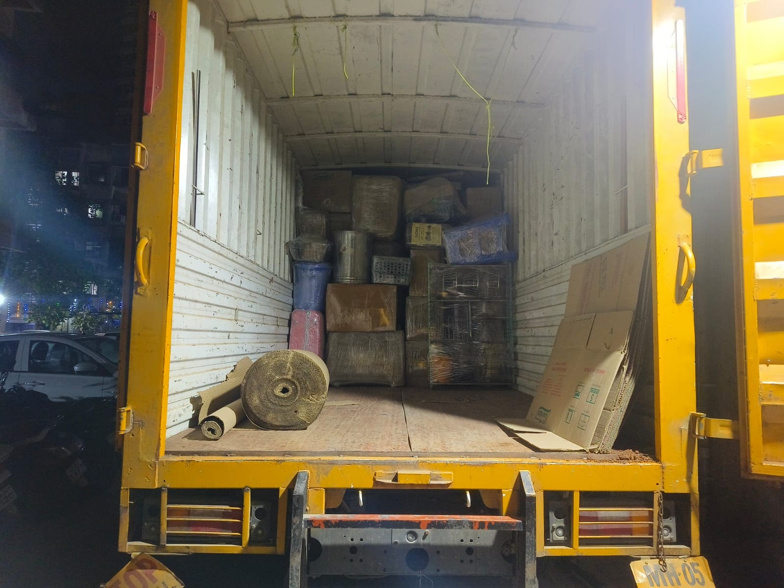 Open moving truck loaded with packed household goods and equipment