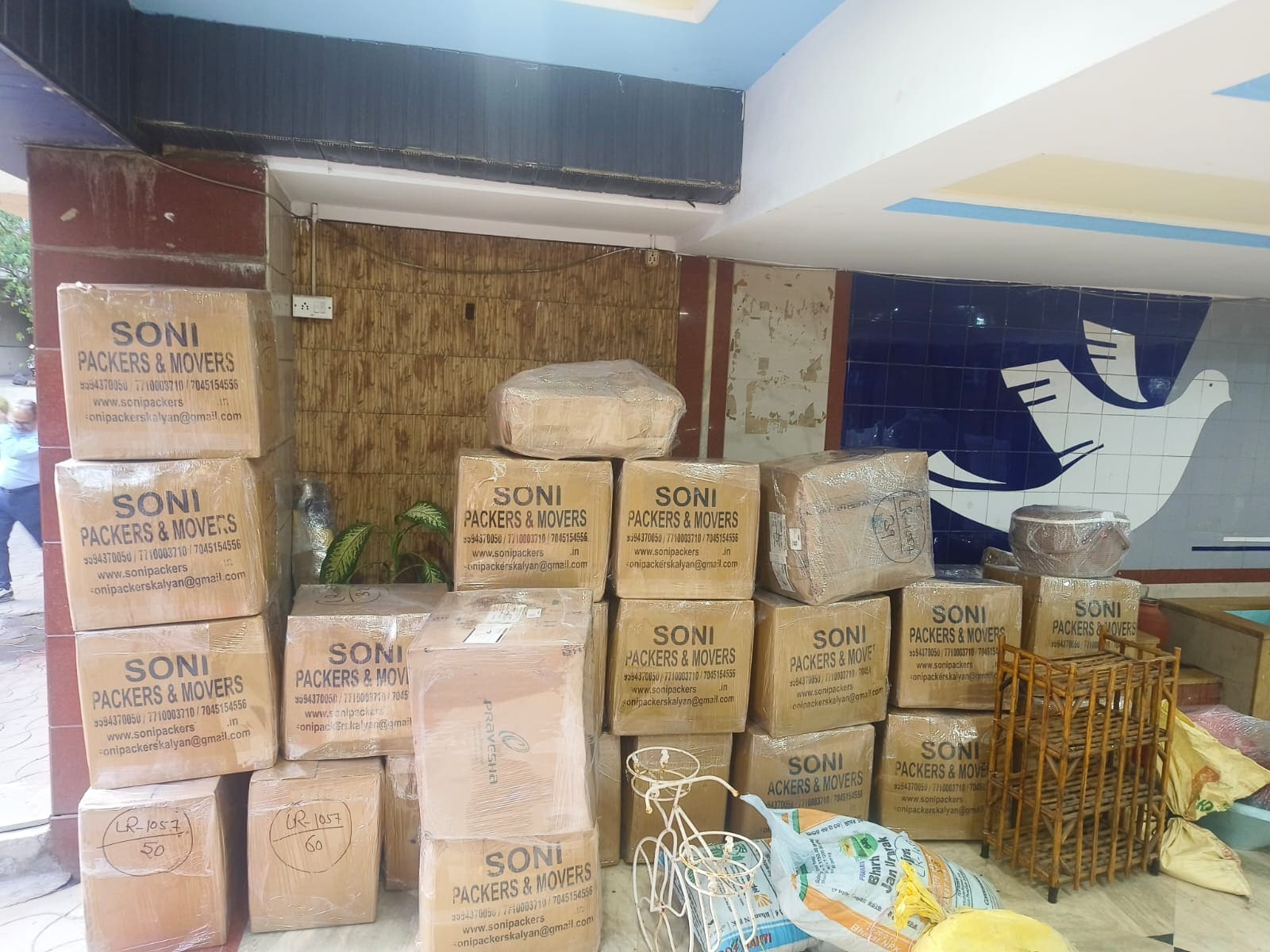 Packed cartons and wrapped items arranged together during a moving job