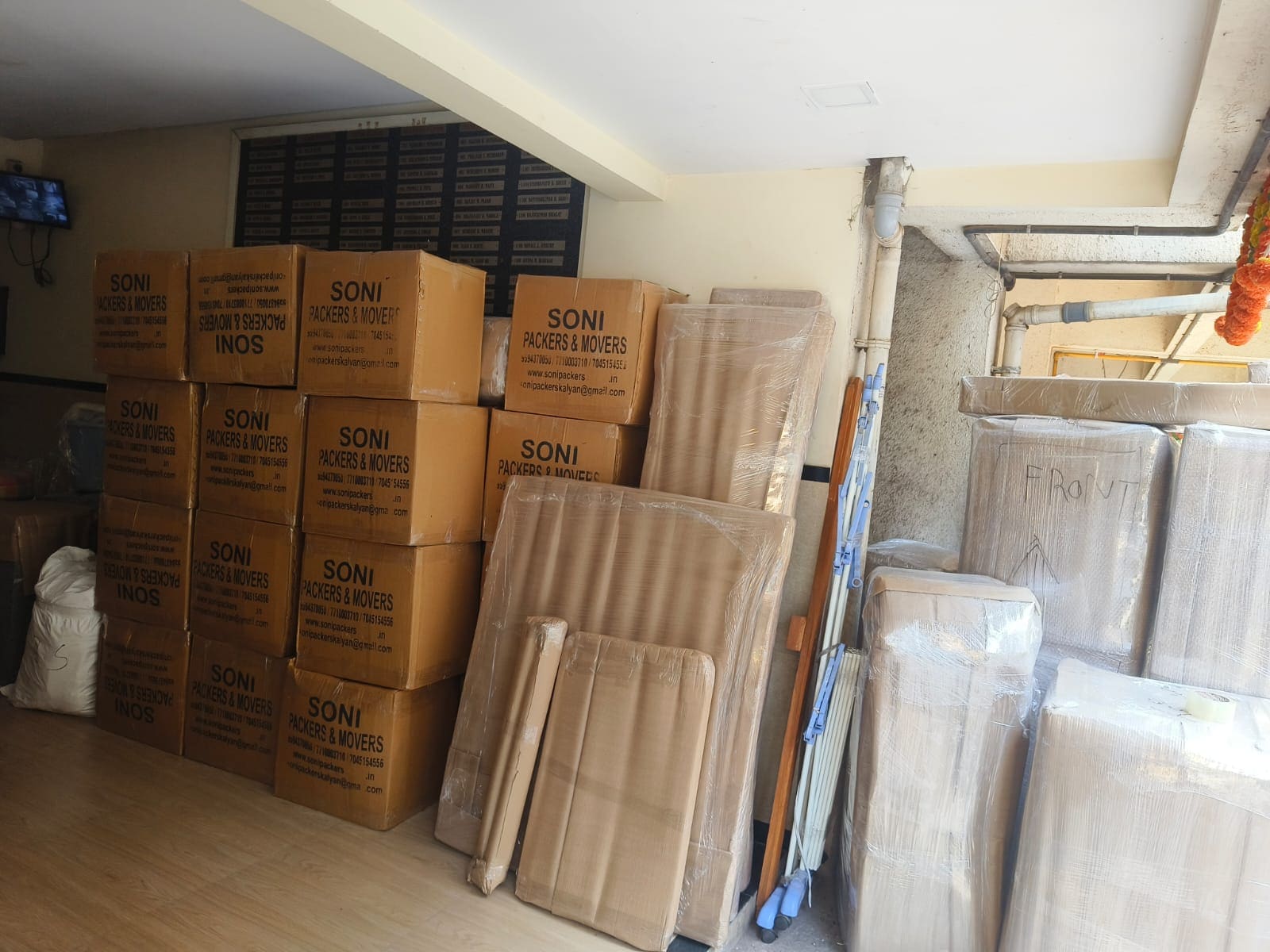 Packed cartons and wrapped household items arranged inside a loading area