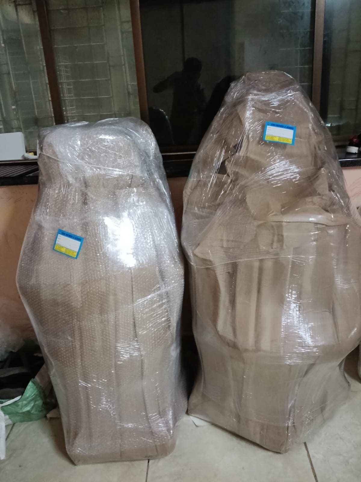 Two office chairs individually wrapped and labelled for relocation