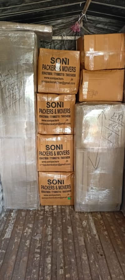 Soni Packers branded cartons stacked inside a moving truck