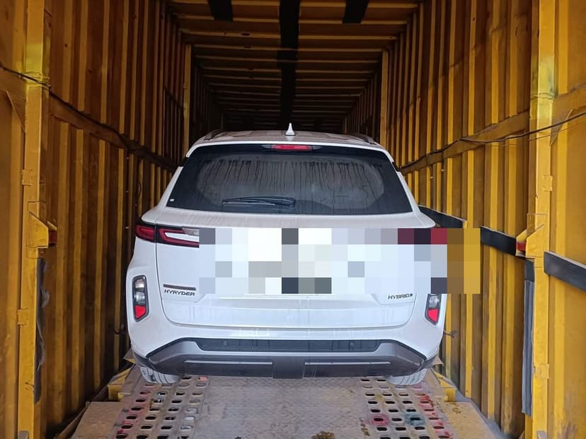 SUV loaded and strapped inside an enclosed car carrier