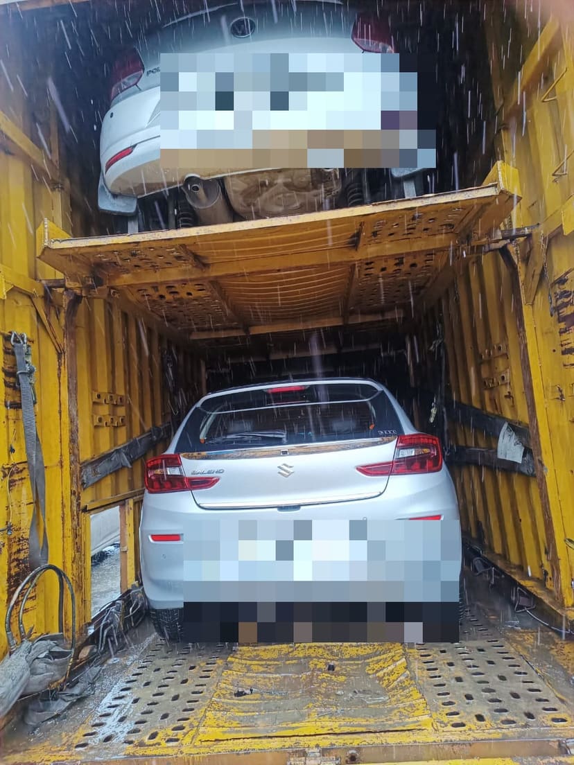 Two cars loaded on the upper and lower decks of a double-deck carrier