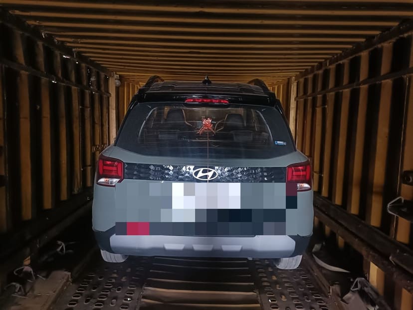 Vehicle positioned inside a transport carrier ready for dispatch